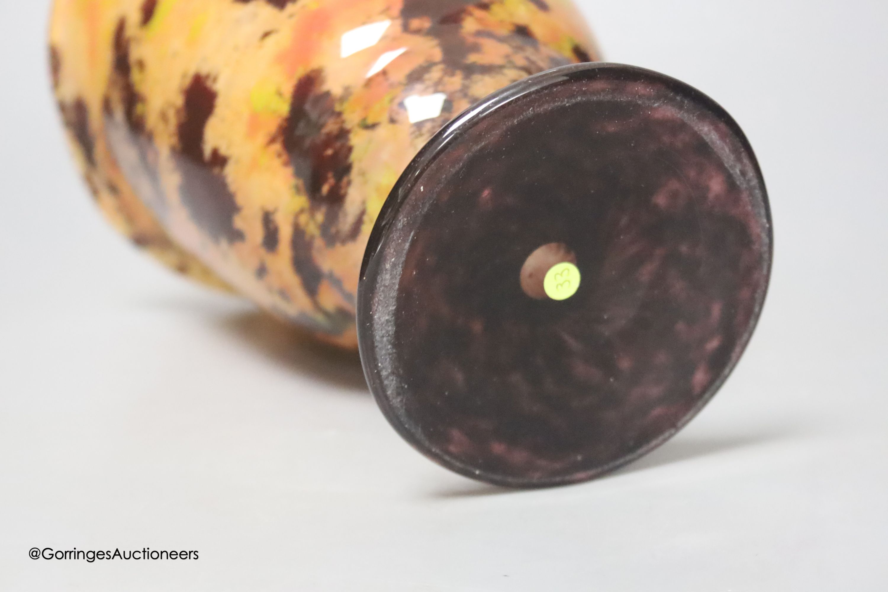 A Schneider multi-coloured pedestal glass vase, signed to base, height 19cm